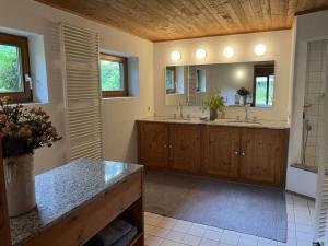 a large bathroom with two sinks and a mirror at Schlechtbach sawmill in Gschwend