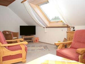 a living room with a skylight and a flat screen tv at Oberrain in the Ferienhaus Schenk 