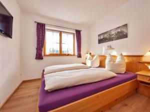 a bedroom with two beds with a purple mattress at "Karwendel" Modern retreat in Krün