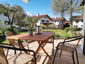a wooden table and chairs on a patio at Favorite place 3 in Garmisch-Partenkirchen