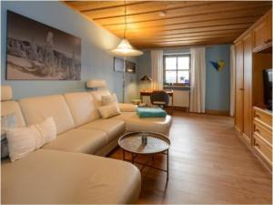 a living room with a couch and a table at Hittenpichl "St Joseph" in Bodenmais