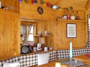 a room with wooden walls and a tv in a cabin at "Gänseliesel" Modern retreat in Willingen