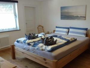 a large bed with blue and white pillows on it at "Gänseliesel" Modern retreat in Willingen
