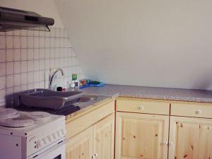 a kitchen with a sink and a stove top oven at at Bunge Heath Farm - formerly TUI Ferienhaus in Uelzen +7 photos