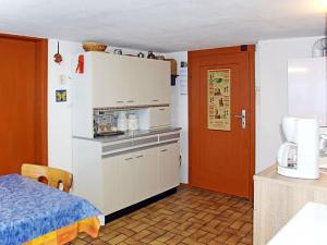 a room with a kitchen with a refrigerator and a bed at Rappenloch Modern retreat in Eisenbach