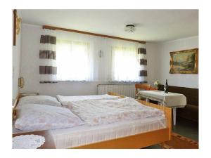 a bedroom with a large bed and a table at Rappenloch Modern retreat in Eisenbach