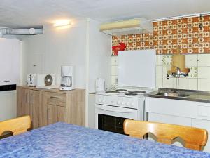 a kitchen with a table and a stove top oven at Rappenloch Modern retreat in Eisenbach +15 photos