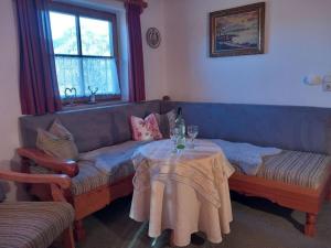 a living room with a couch and a table at Hirschbichler Modern retreat in Berchtesgaden