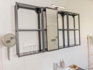a mirror on a wall above a bathroom sink at Luxury apartment Bad Salzuflen in Bad Salzuflen