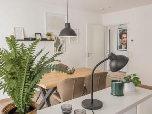 a dining room with a table and a lamp at Luxury apartment Bad Salzuflen in Bad Salzuflen
