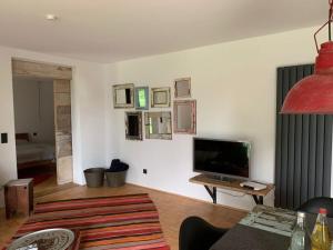 ein Wohnzimmer mit einem Flachbild-TV an der Wand in der Unterkunft 2 with sauna holiday home Poppenhausen in Poppenhausen