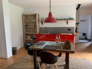 a kitchen with a table and chairs in a room at 2 with sauna holiday home Poppenhausen in Poppenhausen