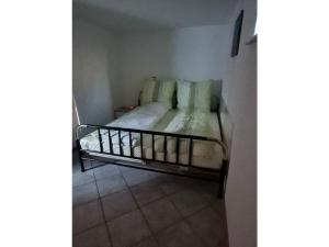 a small bed in a corner of a room at in Schambach Comfortable holiday residence in Eichstetten