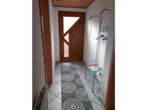 a hallway with a door and a tile floor at in Schambach Comfortable holiday residence in Eichstetten +6 photos