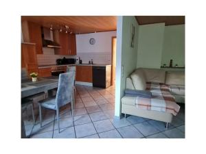a kitchen and a living room with a table and a bed at in Schambach Comfortable holiday residence in Eichstetten