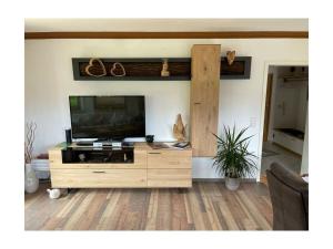 a wooden entertainment center with a flat screen tv in a living room at Valley station Modern retreat in Garmisch-Partenkirchen