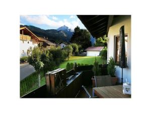 uma varanda de uma casa com vista para um quintal em Valley station Modern retreat em Garmisch-Partenkirchen