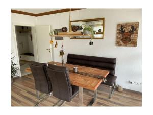 a dining room table with black chairs and a wooden table at Valley station Modern retreat in Garmisch-Partenkirchen