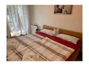 a bed with two pillows on it in a bedroom at Valley station Modern retreat in Garmisch-Partenkirchen +23 photos