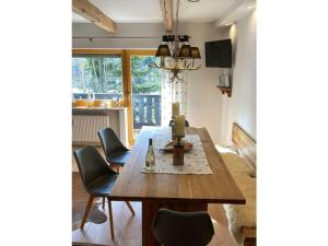 a dining room with a wooden table and chairs at Bergglück Comfortable holiday residence in Reit im Winkl