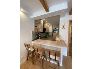 a kitchen with a wooden table and chairs at Bergglück Comfortable holiday residence in Reit im Winkl +5 photos
