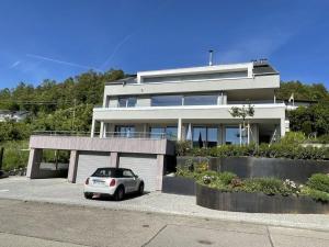 a car parked in front of a large house at Lake Constance Apartment SeeSucht No 86 in Bodman-Ludwigshafen