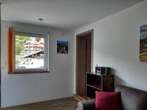 sala de estar con ventana y sofá en Apartment Almrausch, en Berchtesgaden