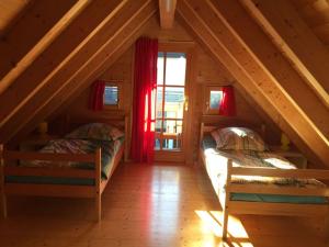 a bedroom with two beds in a attic at Cheese kitchen Bernbeuren in Bernbeuren