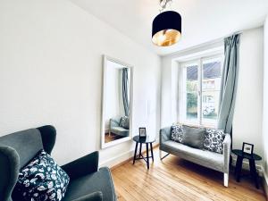 a living room with a couch and a mirror at Business Apartment in Derendingen in Derendingen