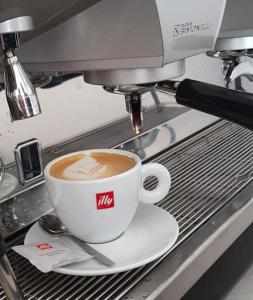 a cup of coffee sitting on a coffee machine at AtlantisPagNovalja in Zubovići