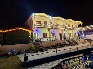 a building with lights on it at night at Haveli Resort in Rishīkesh