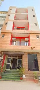 a tall building with stairs in front of it at Roomshala 002 Rose Residency Near Yashobhoomi in New Delhi