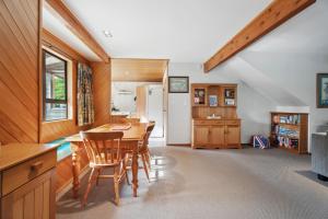 a kitchen with a table and chairs in a room at So Good On Sargood - Wanaka Holiday Home in Wanaka