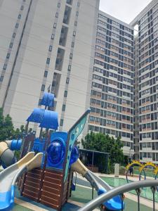 a playground in front of a large building at Horizon Suite Kila Short-term hotel in Sepang