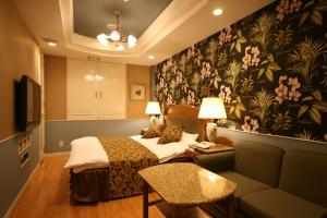 a hotel room with a bed and a couch at D-CUBE奈良店 in Nara