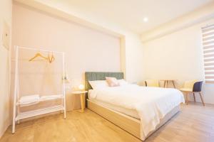 Een bed of bedden in een kamer bij 悠日 Lazy Days 澎湖民宿