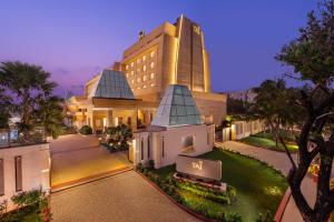 un gran edificio con un cartel en él por la noche en Taj Tirupati en Tirupati