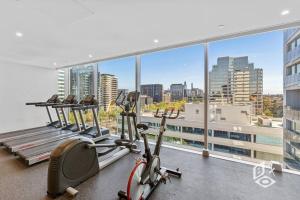 a gym with a view of a city at Rest 1 BedRooms Fawkner APT in Melbourne