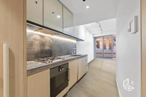 a kitchen with a stove and a counter top at Rest 1 BedRooms Fawkner APT in Melbourne