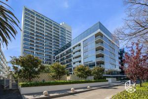 a large glass building with trees in front of it at Rest 1 BedRooms Fawkner APT in Melbourne