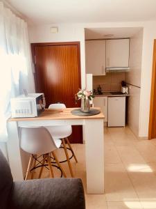 a kitchen with a table with chairs and a microwave at APARTAMENTO 2p MENDIVIL MADRID CENTRO in Madrid