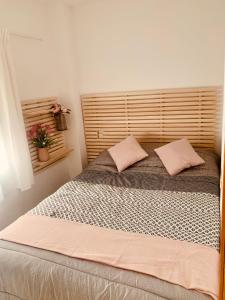 a bedroom with a large bed with two pillows at APARTAMENTO 2p MENDIVIL MADRID CENTRO in Madrid