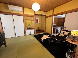 a living room with a chair and a bedroom at Iojima BeachHouse - Vacation STAY 97622v in Nagasaki