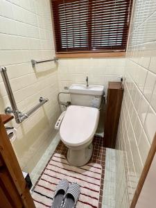 a bathroom with a toilet and a rug at Iojima BeachHouse - Vacation STAY 97622v in Nagasaki
