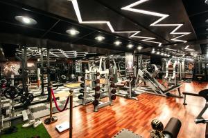 a gym with lots of equipment on a hardwood floor at Central Inn & Spa in Dhaka