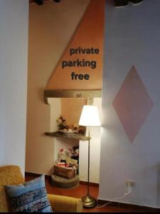 a living room with a sign that reads private parking free at La Piccola Oasi con parcheggio in Florence