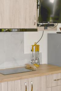 a kitchen counter with some utensils on it at Beach & Chill Apartments in Vlorë