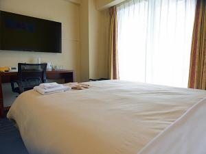Jisco Hotel Obama Onsen客房内的一张或多张床位