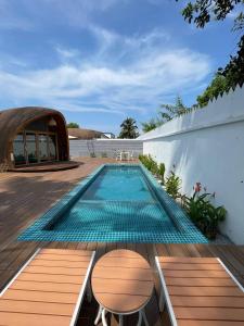 a swimming pool in the middle of a house at Found Mansion in Pantai Cenang