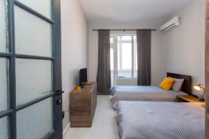 Postel nebo postele na pokoji v ubytování Urban Elegance Apartment